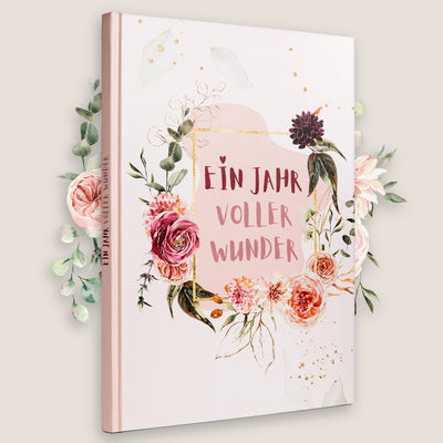 Baby-Erinnerungsalbum 'Ein Jahr voller Wunder' mit floraler Verzierung, ideal zur Dokumentation der ersten Momente im ersten Lebensjahr.