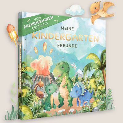 Ein Kindergartenfreundebuch mit dem Titel "Meine Kindergarten Freunde" mit einer farbenfrohen Illustration von Zeichentrick-Dinosauriern, einem Vulkan und Palmen. Der Einband trägt den goldenen Schriftzug "Von Erzieherinnen Gestaltet".
