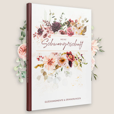 "Cover des Schwangerschaftstagebuchs 'Meine Schwangerschaft' mit floralen Motiven und der Aufschrift '84 Seiten, Glücksmomente & Erinnerungen'."